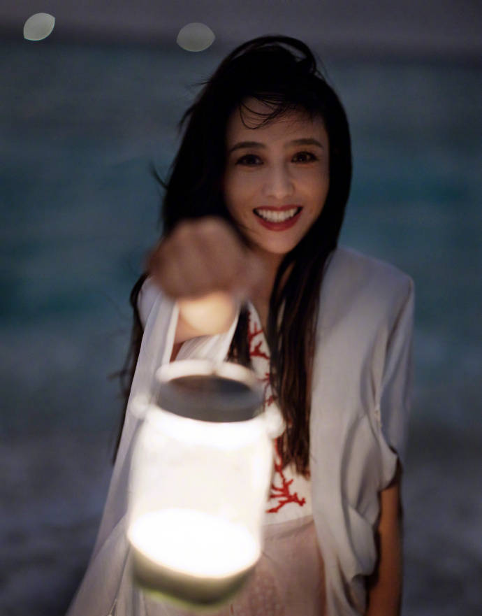 佟丽娅晒海滩美照 笑颜提灯妙似少女